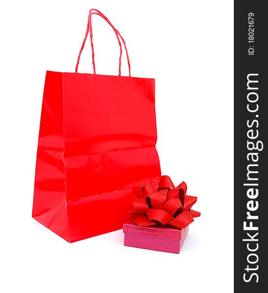 A gift wrapped box in a red bag