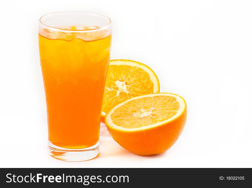 Orange juice in glass with half cut fresh oranges