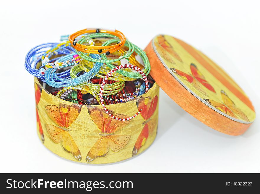 Many colorful fashion bracelets in box on white background