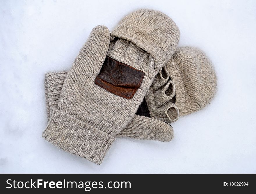 A pair of brown wool mittens
