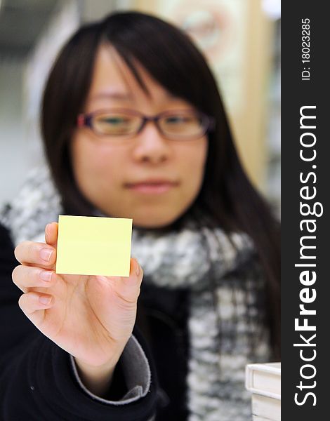 A Girl Who Is Holding A Yellow Memo Notepaper