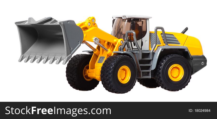 The toy heavy bulldozer of yellow color on a white background