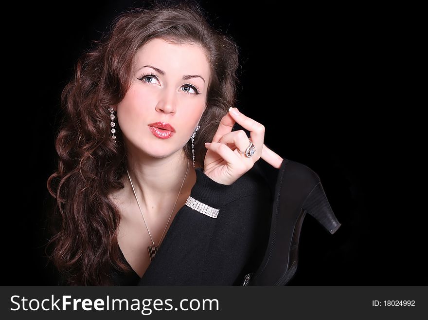 Beautiful elegant woman holding a shoe