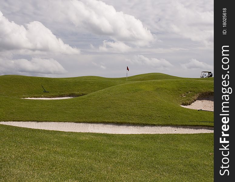 Sand traps protect the green at the golf course