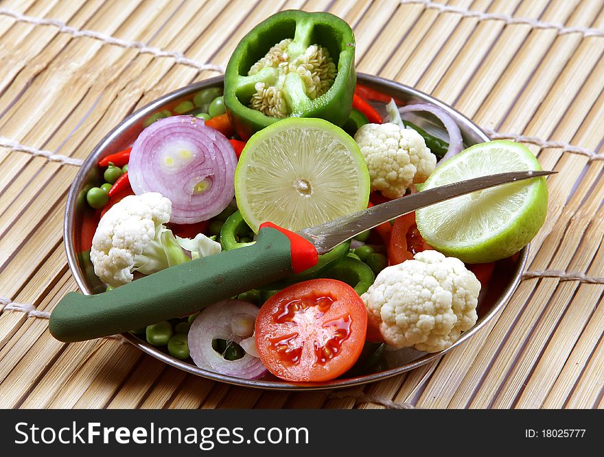 Fresh mixed vegetable in steel plate over wooden background. Fresh mixed vegetable in steel plate over wooden background.