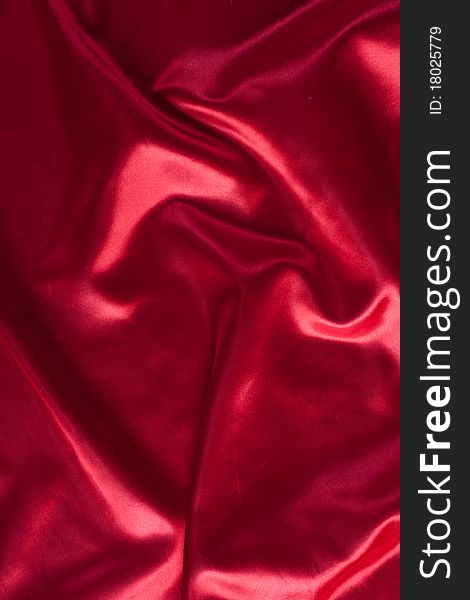 Red silk texture with folds can be used as a background. Red silk texture with folds can be used as a background
