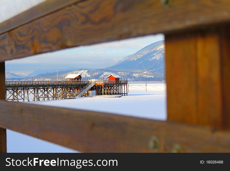 Wooden pier with snow at frozen lake in Salmon Arm