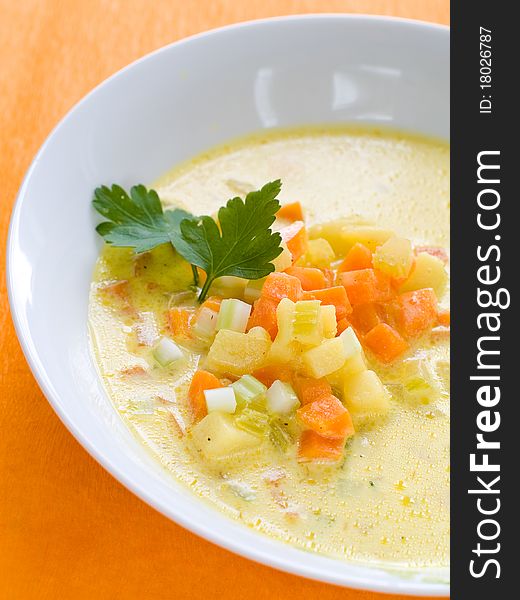 Vegetable soup with carrot, cabbage and potatoes in bowl