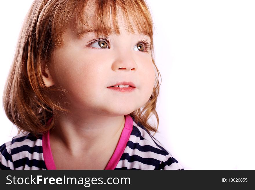 An adorable little girl smiling in front of a white background. An adorable little girl smiling in front of a white background.