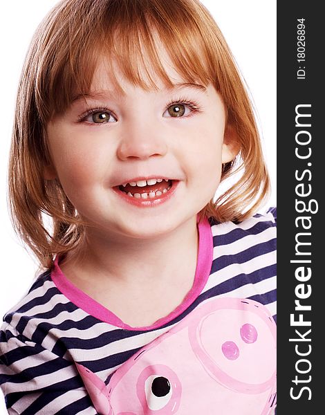 An adorable little girl laughing in front of a white background. An adorable little girl laughing in front of a white background.