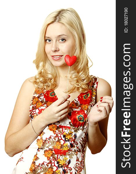 Close-up of a beautiful young woman with a red heart. Isolated on a white background