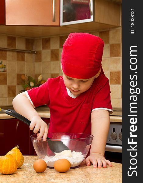 Small Boy In Kitchen With Baking