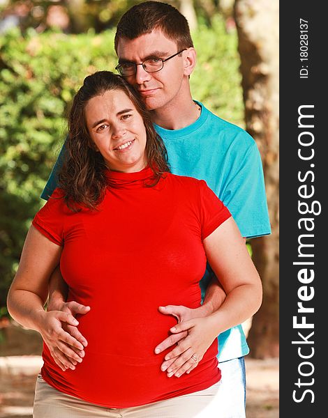 Portrait of a Expecting couple on the park
