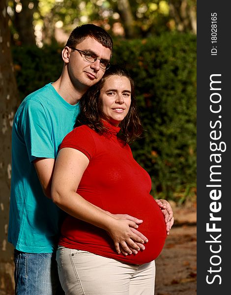 Portrait of a Expecting couple on the park