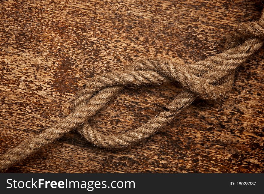 Rope on dirty wood background