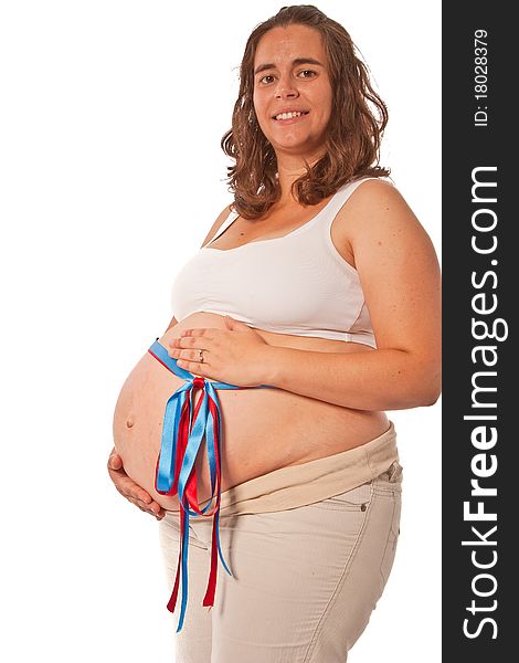 Pregnant belly with a red and blue ribbon concept of expecting twins or not knowing if is't a boy or girl. Pregnant belly with a red and blue ribbon concept of expecting twins or not knowing if is't a boy or girl