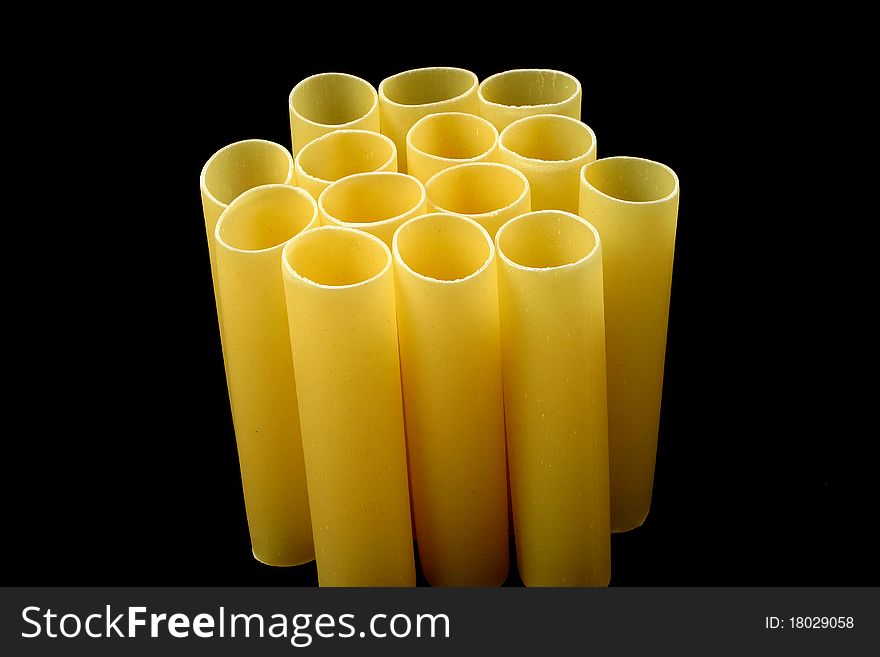 Cannelloni pasta tubes on a black background. Cannelloni pasta tubes on a black background
