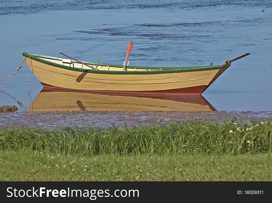 This lone double ender boat was very calm in the water. This lone double ender boat was very calm in the water.