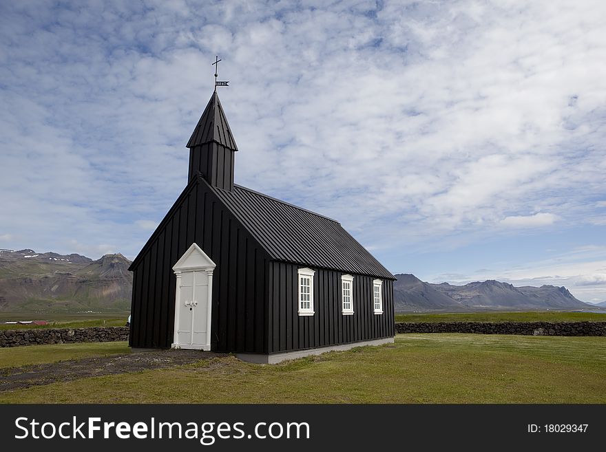 The Budir church is in the benefice of Ingjaldsholl and the Snaefell- and Dalir Deanery. The first church was built there in 1703. It was later demolished and a new one constructed. In 1816, the parish was abolished and the church was dismantled. One of the ladies of the parish fought strongly for a new church and eventually received a royal permission to build a new one, which stood ready in 1848. In 1987, it was reconstructed and consecrated the same year. Among the valuable possessions of the church are a bell from 1672 and another one without the construction year, an altarpiece from 1750, an old silver chalice, two messing candlesticks from 1767, and a door ring from 1703. The crucifix on the altar was made and donated by the goldsmith Jens Gudjonsson. The Budir church is in the benefice of Ingjaldsholl and the Snaefell- and Dalir Deanery. The first church was built there in 1703. It was later demolished and a new one constructed. In 1816, the parish was abolished and the church was dismantled. One of the ladies of the parish fought strongly for a new church and eventually received a royal permission to build a new one, which stood ready in 1848. In 1987, it was reconstructed and consecrated the same year. Among the valuable possessions of the church are a bell from 1672 and another one without the construction year, an altarpiece from 1750, an old silver chalice, two messing candlesticks from 1767, and a door ring from 1703. The crucifix on the altar was made and donated by the goldsmith Jens Gudjonsson.