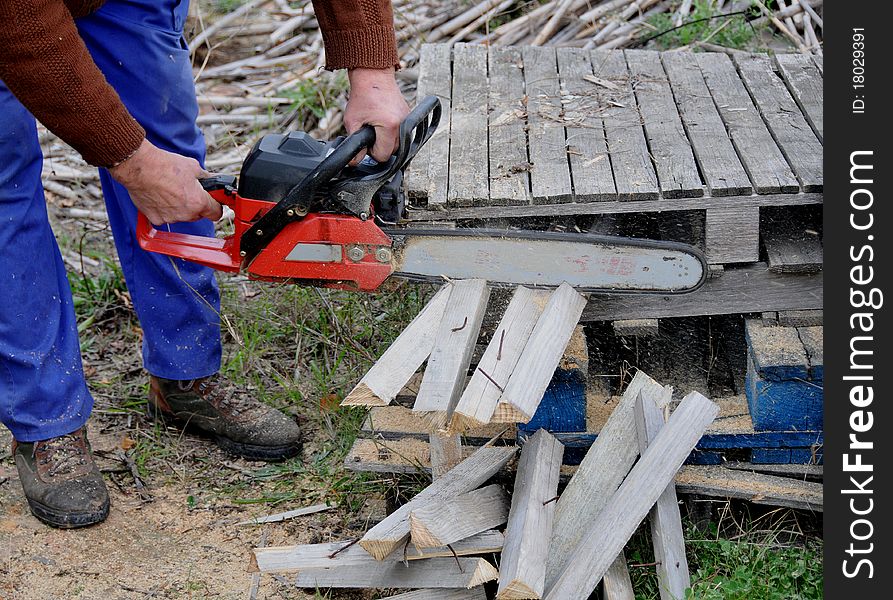 Man with mountain cutting wooden planks. Man with mountain cutting wooden planks