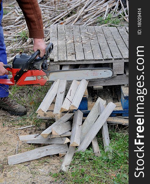 Man with mountain cutting wooden planks. Man with mountain cutting wooden planks