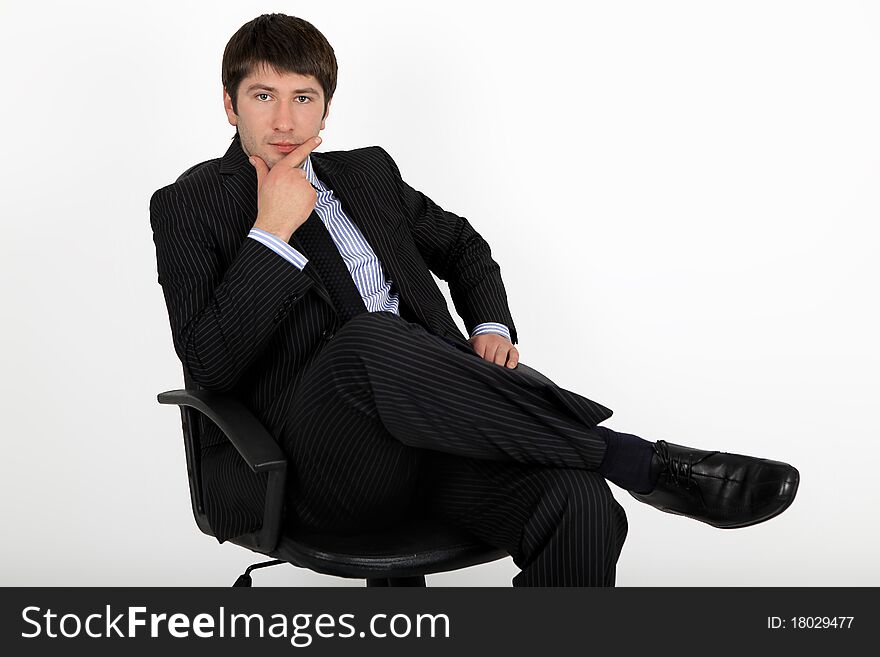 Businessman sitting in an armchair and think about a new project