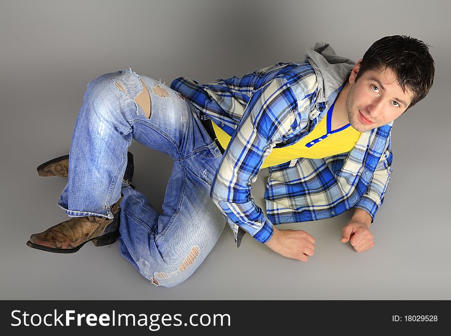 Stylish young man in jeans dancing at a party