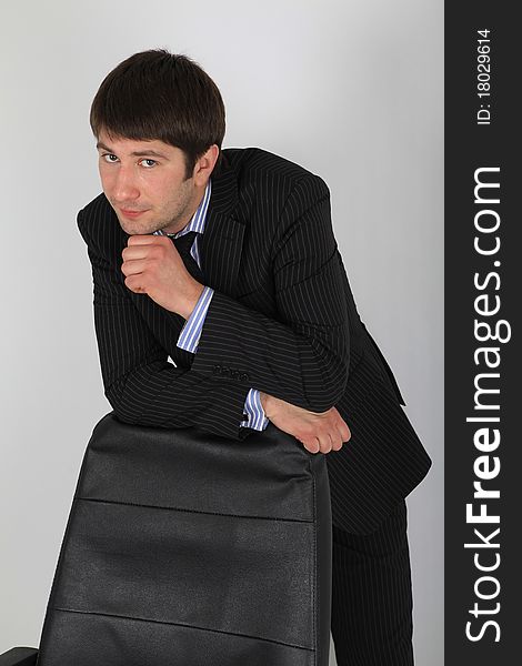 Man in business suit leaning back in his chair. Man in business suit leaning back in his chair