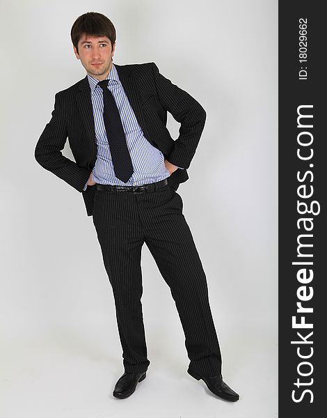Man in a business suit in a full length poses