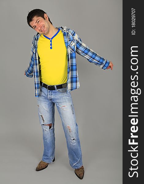 Man in jeans and a plaid shirt and a yellow T-shir