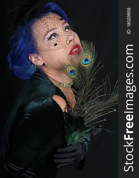 A sexy woman wearing peacock feathers. A sexy woman wearing peacock feathers