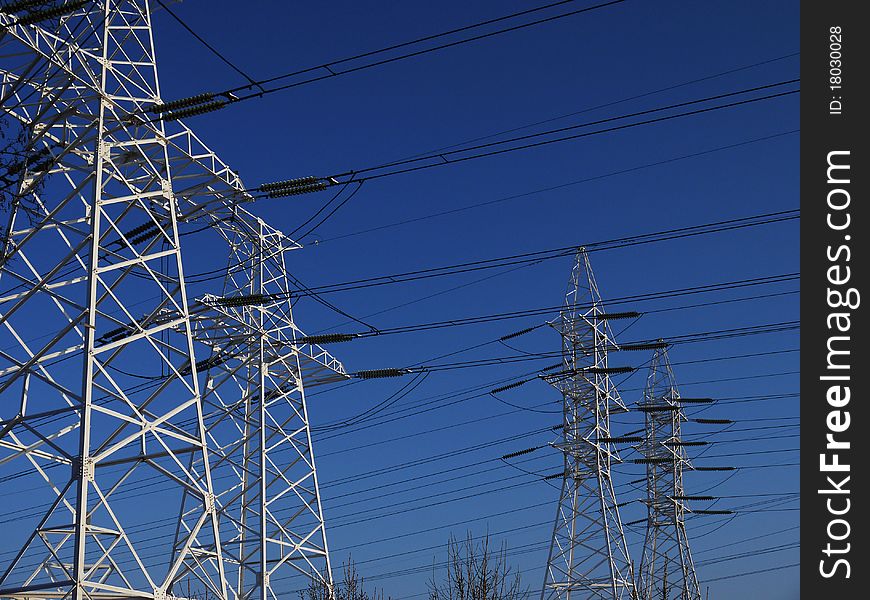 Mast high voltage lines against the background blue sky