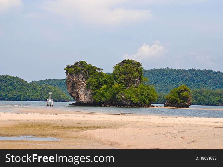 Small island with snad beach in blue sky. Small island with snad beach in blue sky.