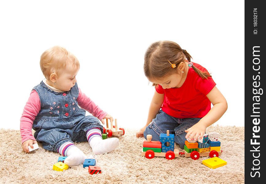 Adorable sisters playing with wood train. Adorable sisters playing with wood train