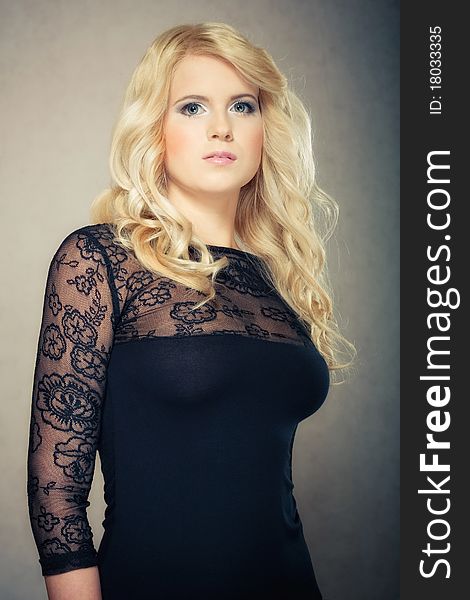 Attractive blond portrait girl in black dress