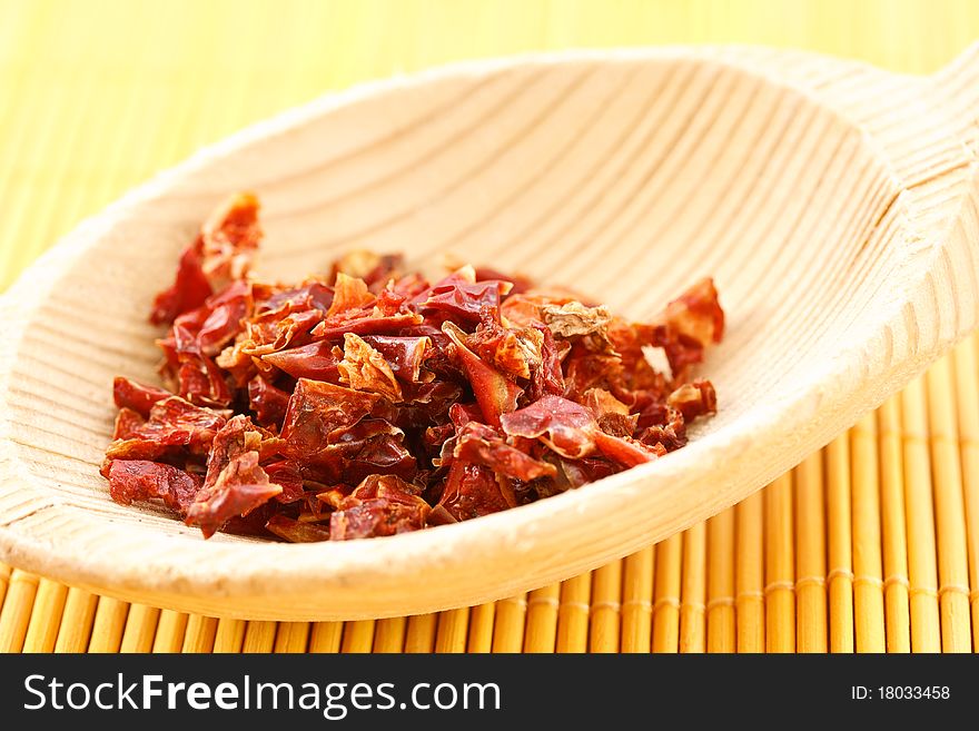 Red chili pepper on a wooden spoon