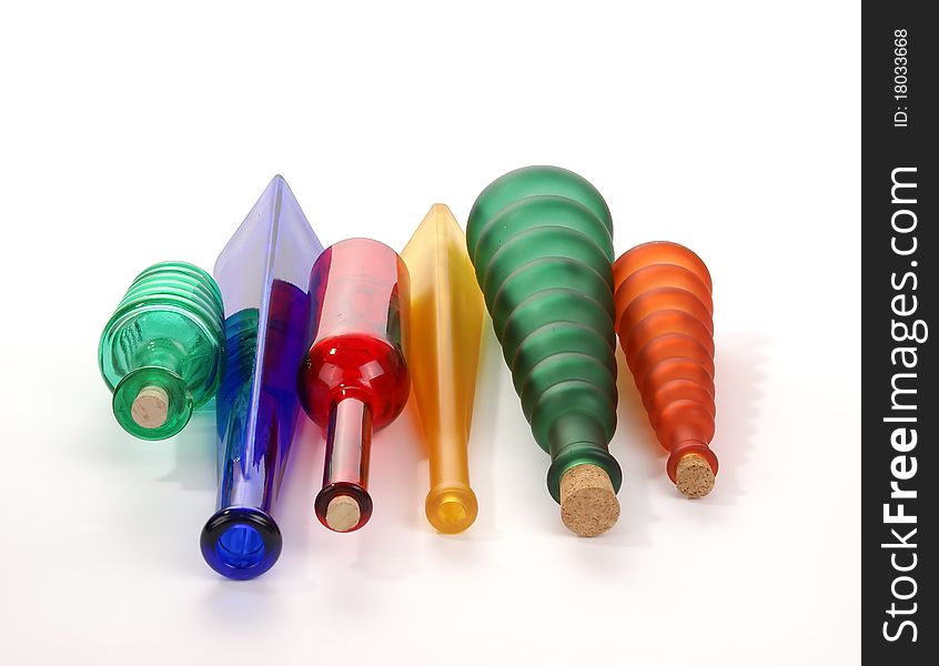 Colored glass vases on a white background