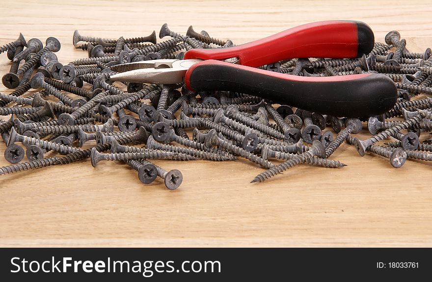 Pile Of Old Screws And Pliers