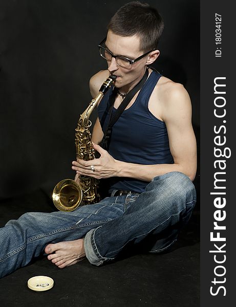 Young jazzman plays a saxophone