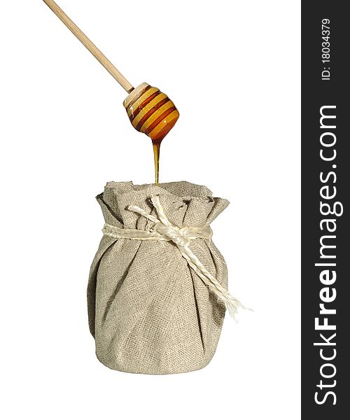 Jar of honey in canvas on white background