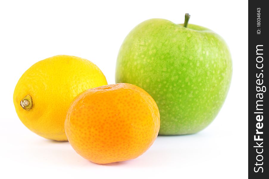 Apple, tangerine and lemon on a white background. Apple, tangerine and lemon on a white background.
