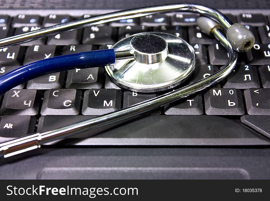 Stethoscope on the notebook's keyboard. Stethoscope on the notebook's keyboard