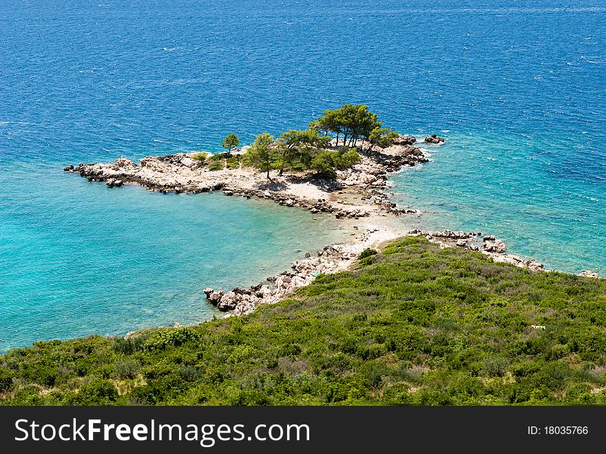 Promontory with trees on the blue sea in Croatia. Promontory with trees on the blue sea in Croatia