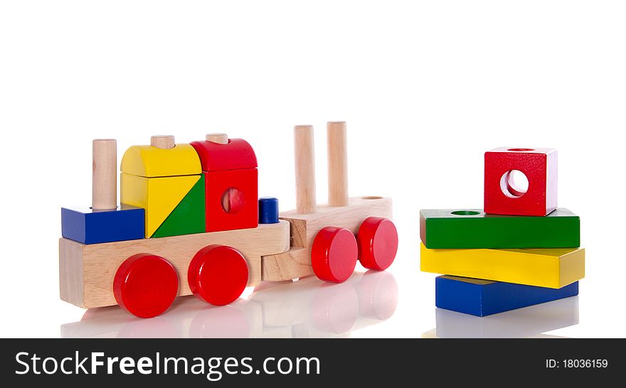 Stacked wooden toy blocks and an educative wooden train isolated over white. Stacked wooden toy blocks and an educative wooden train isolated over white