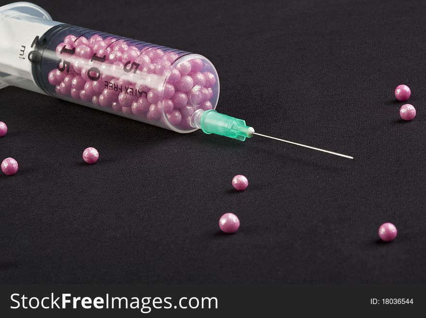 Syringe filled with pink candy