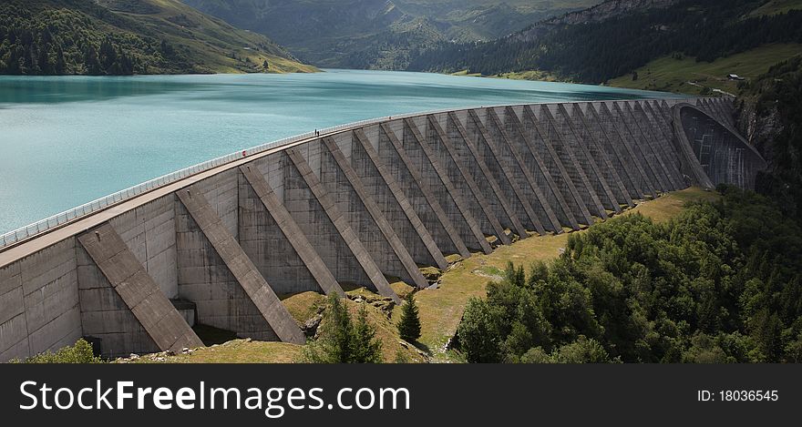 Lake and weir in alpine mountain in France on summer. Lake and weir in alpine mountain in France on summer