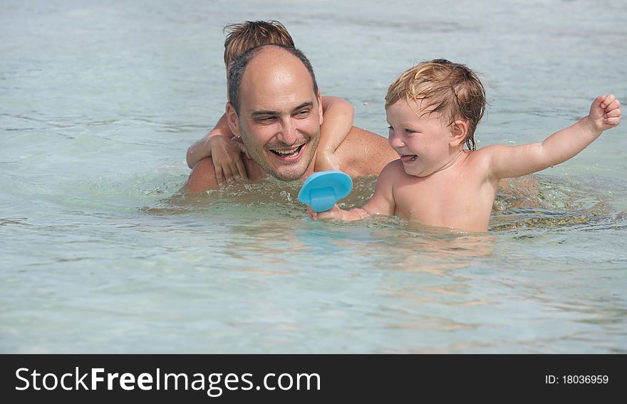 Happy family playing in water. Happy family playing in water