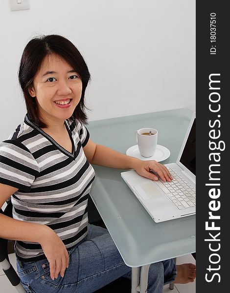 An Asian woman working at home. An Asian woman working at home