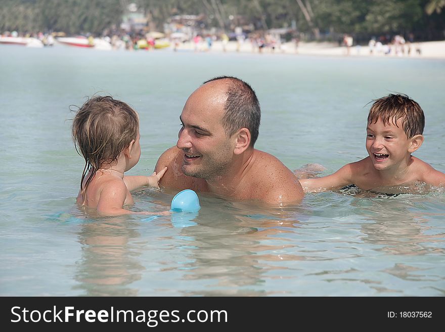 Happy family playing in water. Happy family playing in water