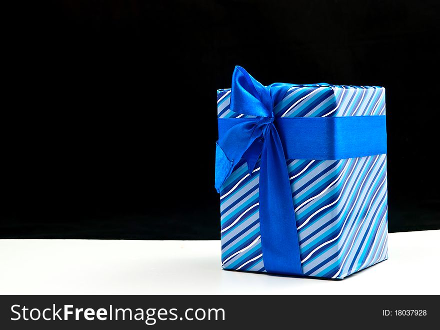 Blue paper gift box. On black and white background. Blue paper gift box. On black and white background